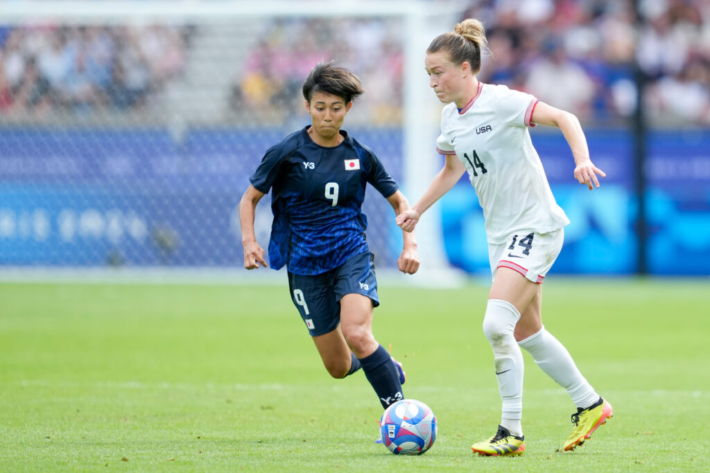 USWNT defender Emily Sonnett dribbles past Japan's Ueki Riko during the 2024 Olympics quarterfinal match.