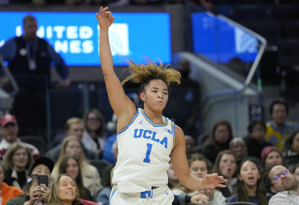 UCLA star Kiki Rice celebrates a three-point shot during a game.