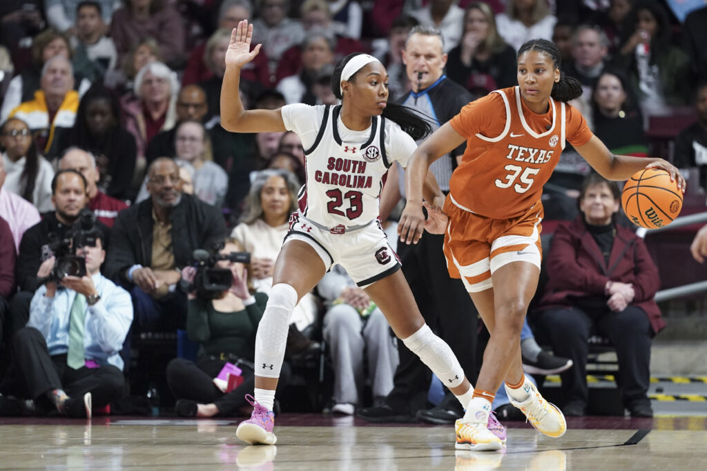 South Carolina's Bree Hall defends Texas guard Madison Booker during a 2024 NCAA basketball game.