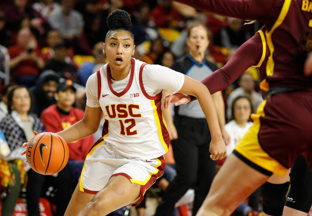 USC superstar JuJu Watkins drives toward the basket during a Big Ten basketball game.