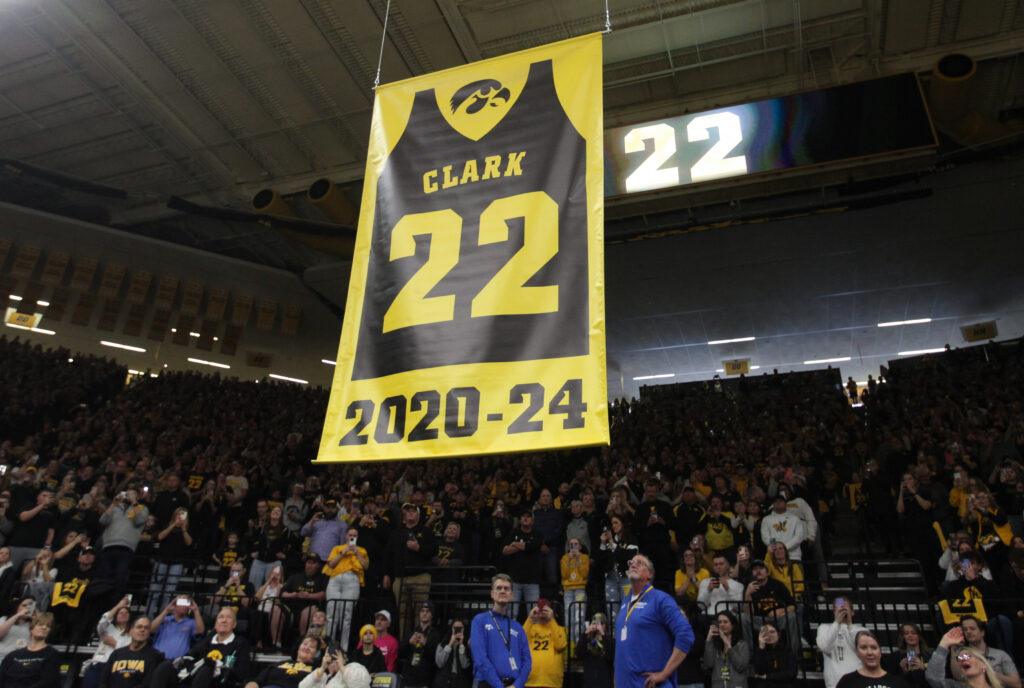 Caitlin Clark's No. 22 is raised into Iowa's rafters at her jersey retirement ceremony.