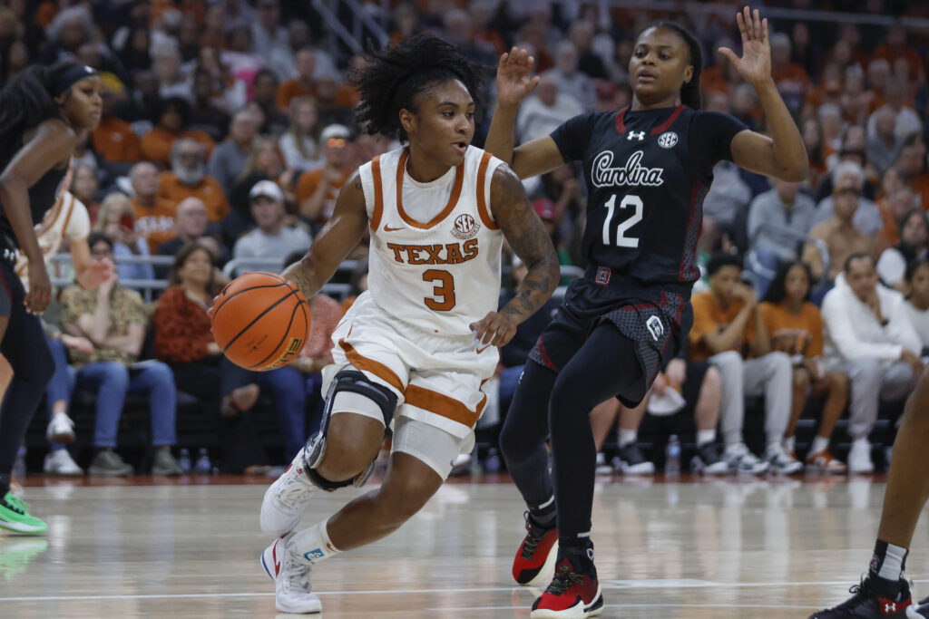 Texas guard Rori Harmon dribbles past South Carolina's MiLaysia Fulwiley during a 2025 NCAA basketball game.