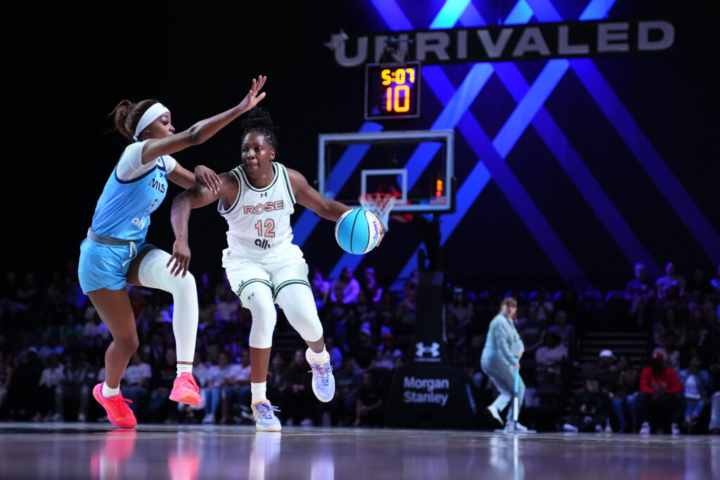 Chelsea Gray #12 of Rose dribbles the ball against Rickea Jackson #5 of the Mist during an Unrivaled 3x3 Basketball game.