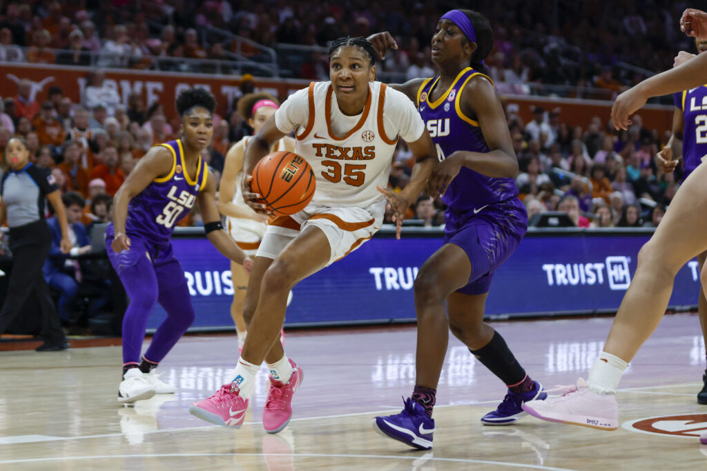 Texas forward Madison Booker drives past LSU's Flau'Jae Johnson in Sunday's NCAA basketball tilt.