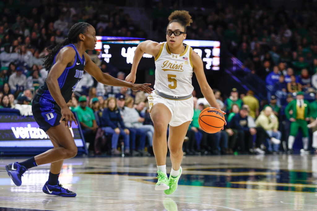 Notre Dame's Olivia Miles dribbles past Duke's Jadyn Donovan during a 2025 NCAA basketball game.