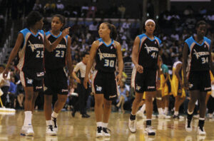 The Cleveland Rockers walk across the court during a 2001 WNBA game.