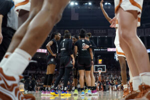 South Carolina huddles before a free throw during a 2025 SEC basketball game against Texas.