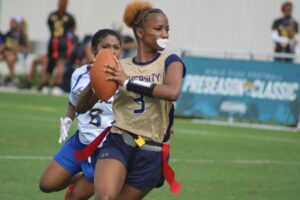 Girl's flag football players compete in a 2025 preseason high school game in Florida.