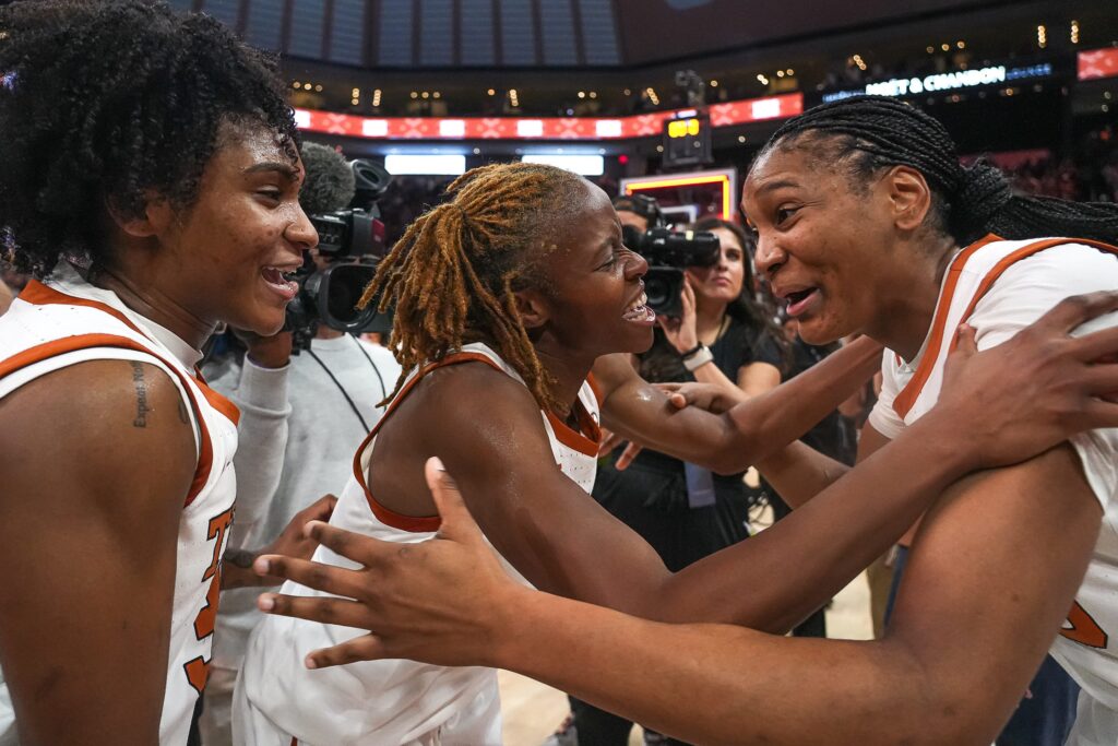 Texas guards Madison Booker, Bryanna Preston, and Rori Harmon celebrate a win earlier this month.