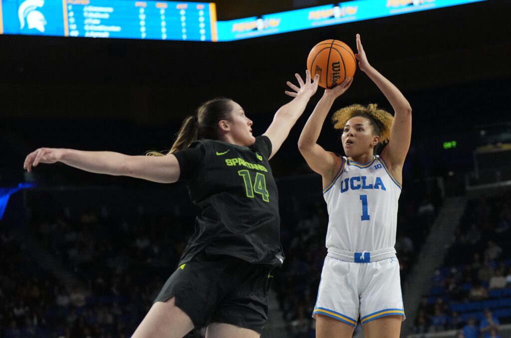 UCLA guard Kiki Rice shoots over Michigan State's Grace Van Slooten on Sunday.