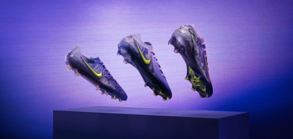 Three nike united pack women's soccer cleats hover against a purple background.