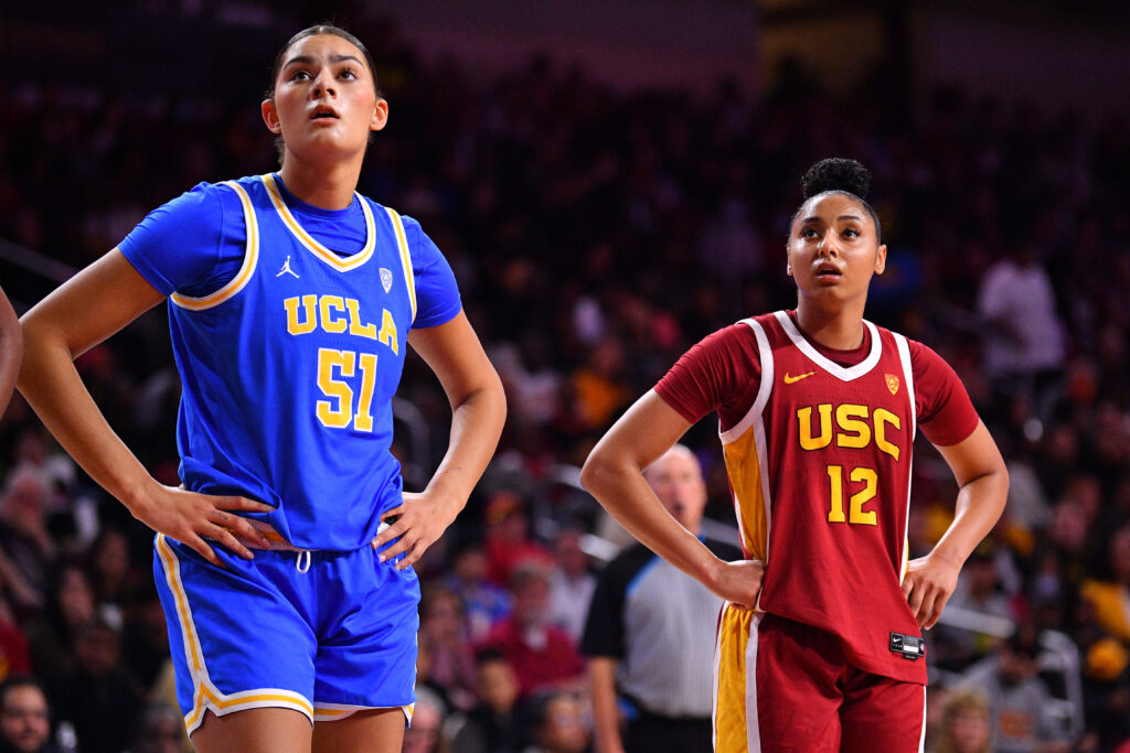 UCLA's Lauren Betts and USC's JuJu Watkins look up during an NCAA basketball game.