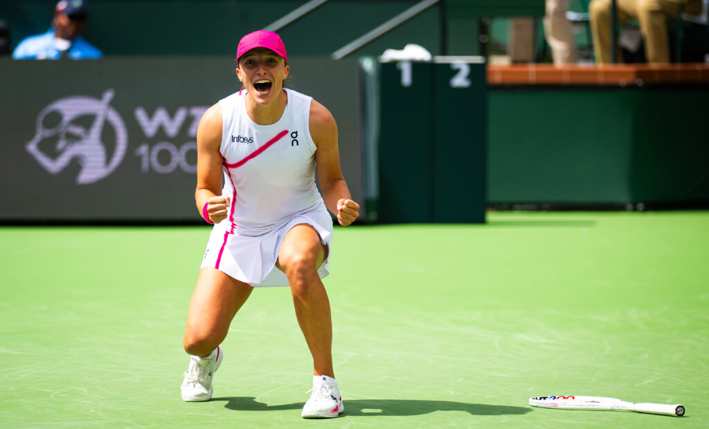 Iga Świątek triumphantly reacts to winning the 2024 BNP Paribas Open at Indian Wells.