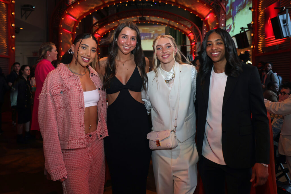 UConn players Azzi Fudd, Caroline Ducharme, Paige Bueckers, and Aubrey Griffin pose for a photo at the 2024 WNBA Draft.