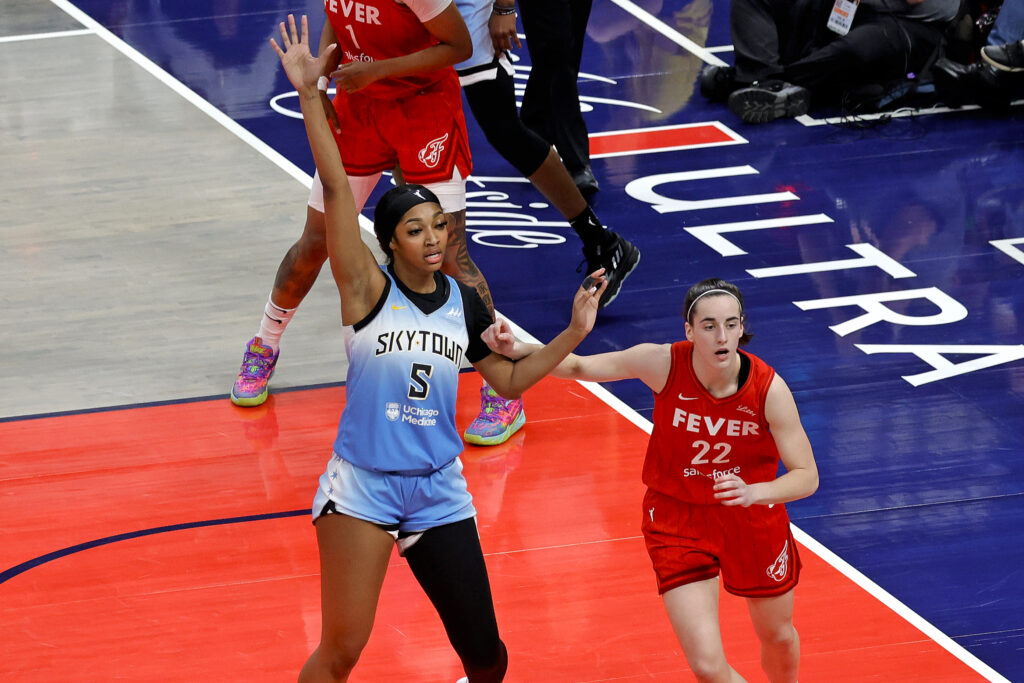 Indiana Fever star Caitlin Clark guards Chicago Sky standout Angel Reese in the paint during a 2024 WNBA game.