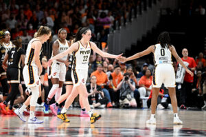 Indiana Fever guard Caitlin Clark celebrates a play with teammate Kelsey Mitchell during a 2024 WNBA game.