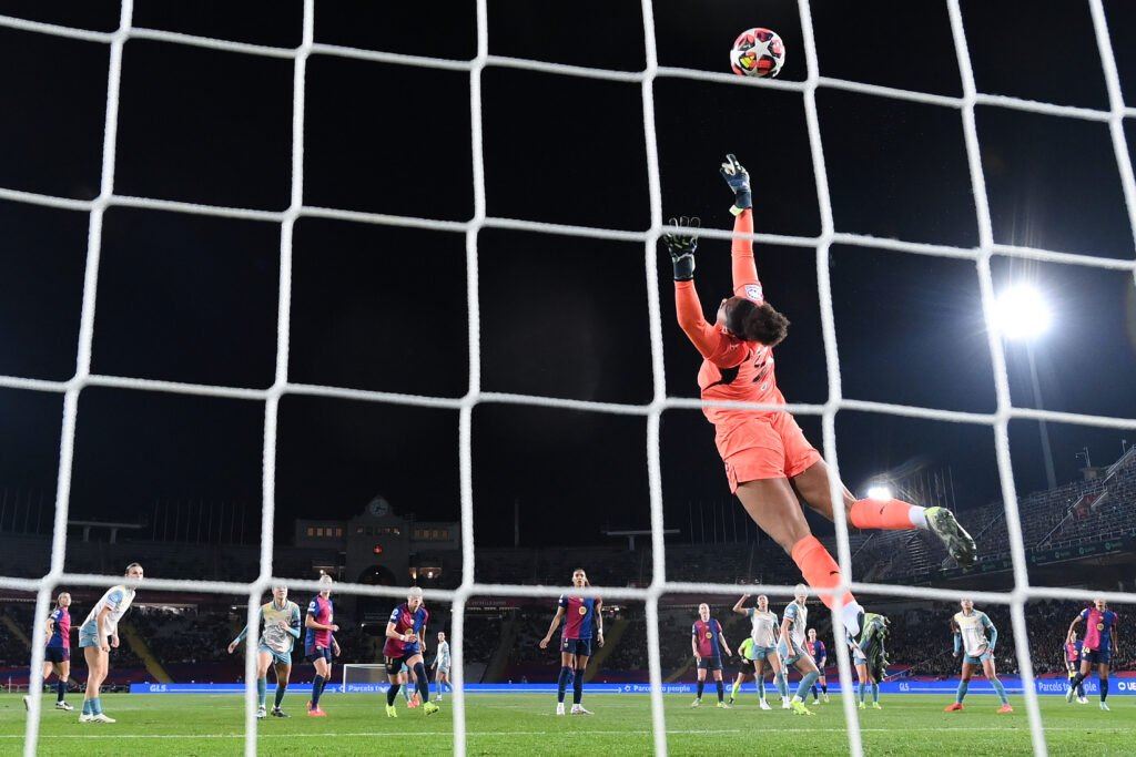 Manchester City goalkeeper Khiara Keating makes a save during a 2024 Champions League match against Barcelona.