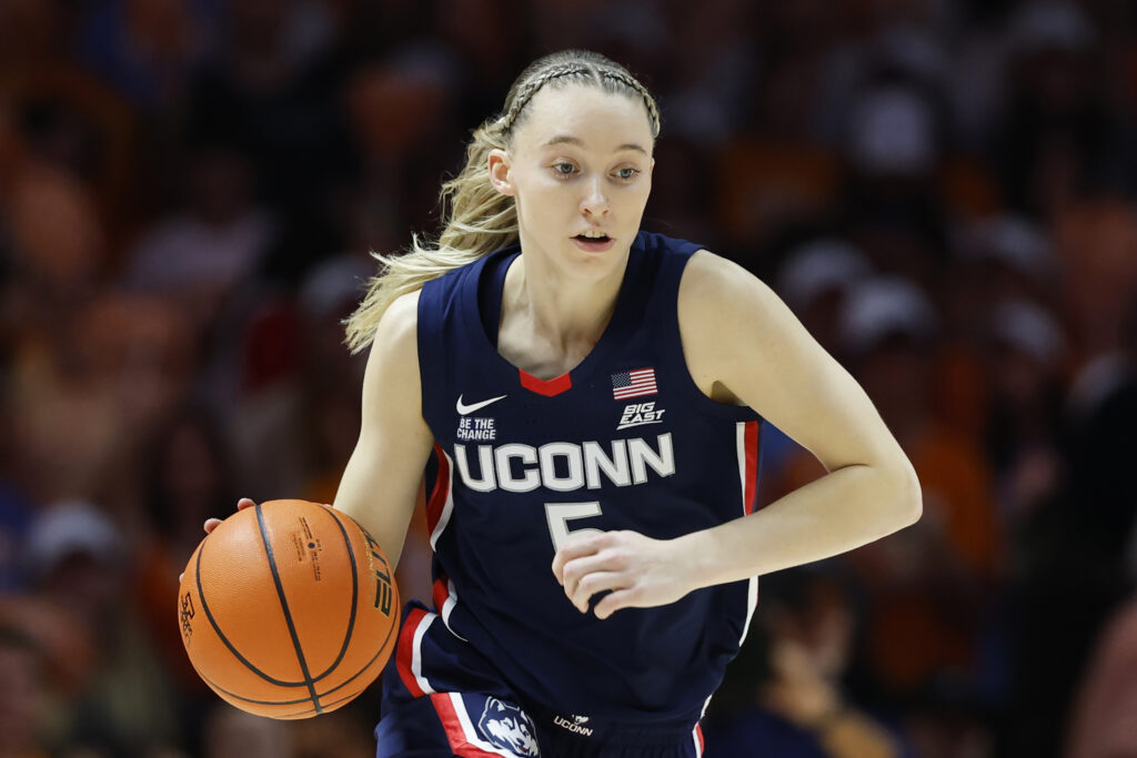 UConn star Paige Bueckers dribbles the ball during a 2025 NCAA basketball game.