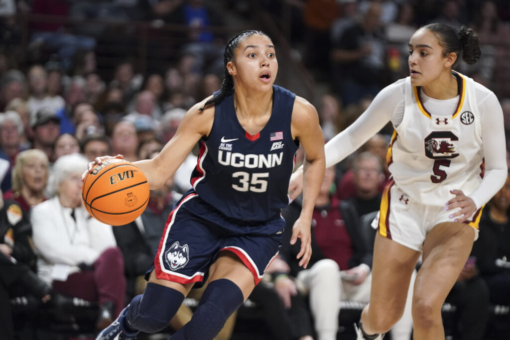 UConn's Azzi Fudd dribbles past South Carolina's Tessa Johnson during their 2025 NCAA basketball game.