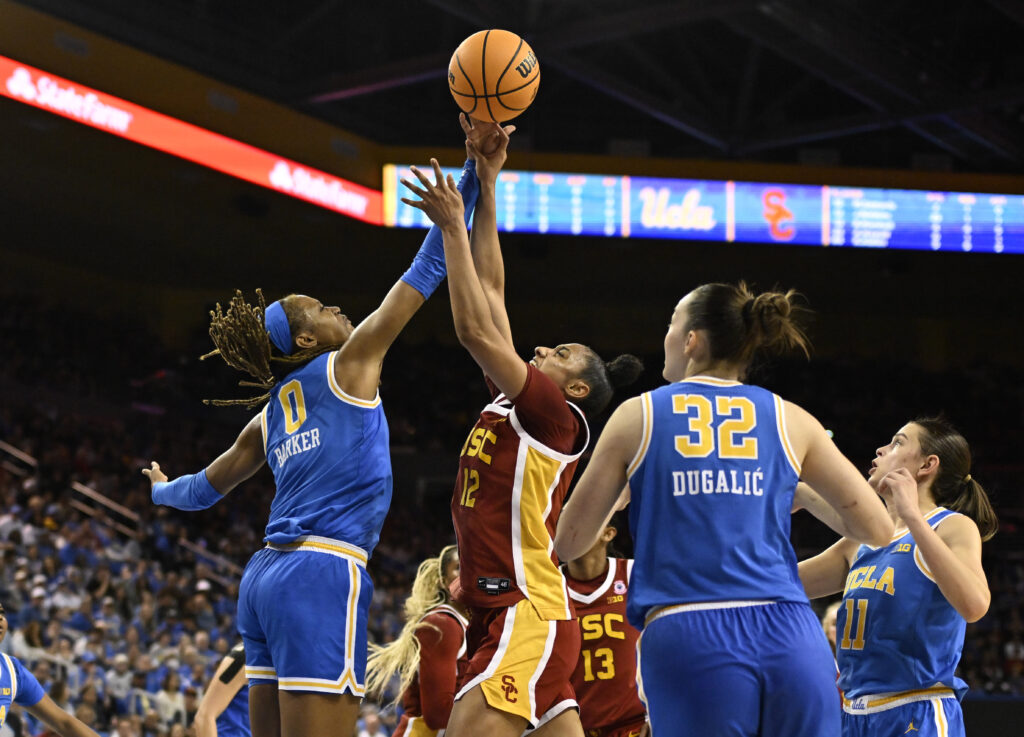 UCLA's Janiah Barker fouls a shot from USC's JuJu Watkins during their Saturday game.