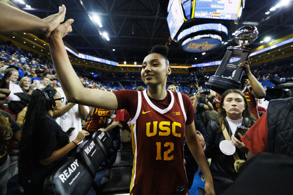 JuJu Watkins celebrates USC's Big Ten basketball title after defeating UCLA on Saturday.