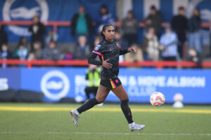 Naomi Girma runs across the pitch during her Chelsea FC debut on Sunday.