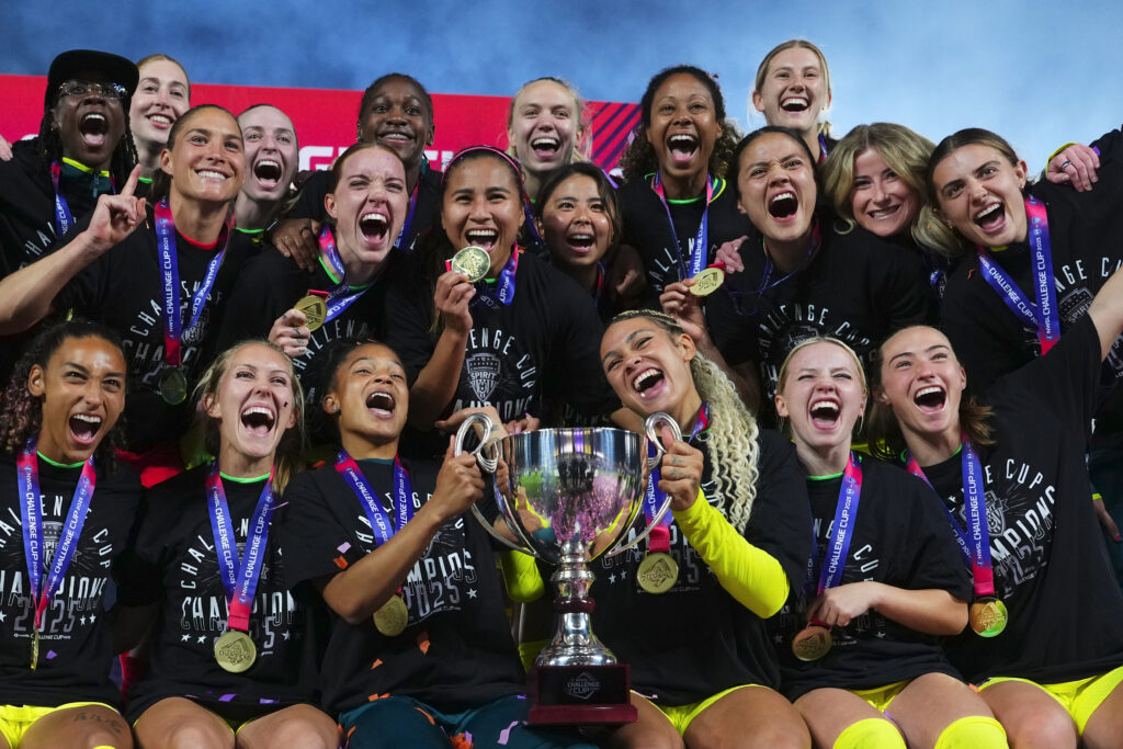 The Washington Spirit holds their 2025 NWSL Challenge Cup trophy after defeating the Orlando Pride.