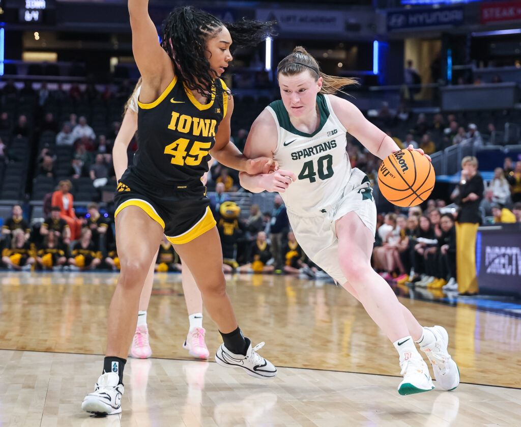 Iowa's Hannah Stuelke defends Michigan State's Julia Ayrault during a 2025 Big Ten basketball tournament game.