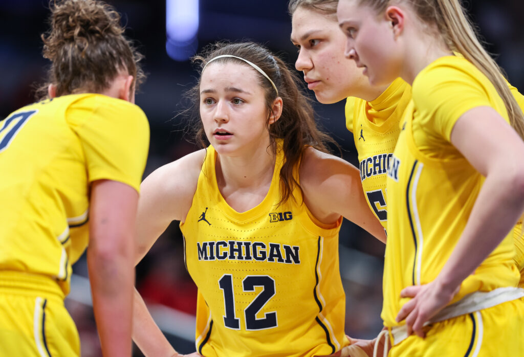 Michigan basketball's Syla Swords listens in a team huddle.