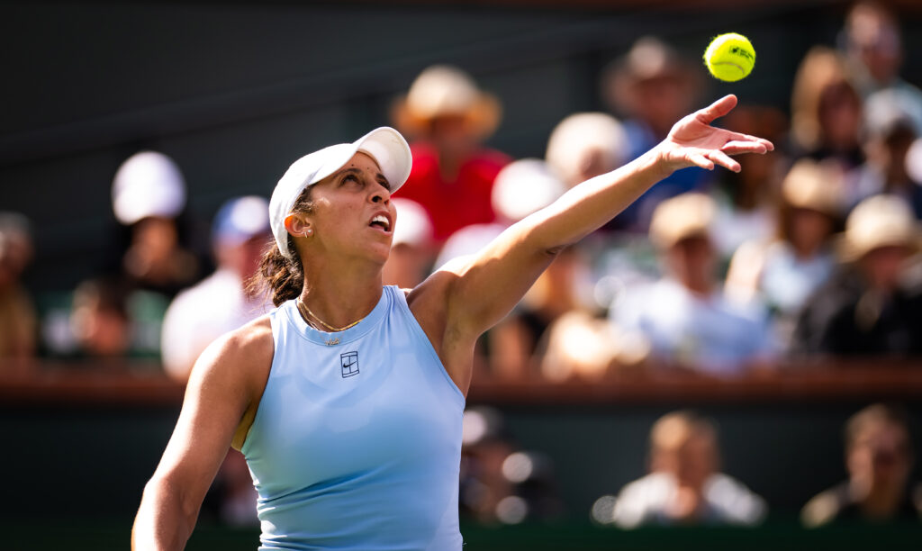 US tennis star Madison Keys tosses up a serve during her 2025 Indian Wells Round of 16 victory.