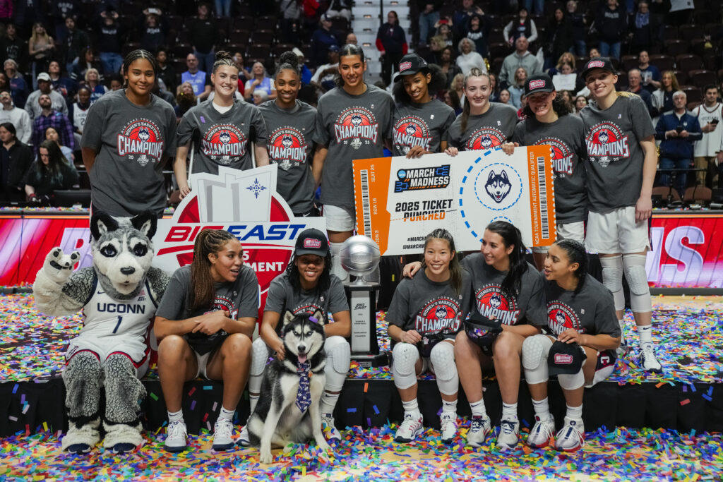 UConn basketball poses with their 2025 Big East tournament trophy.