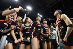 New mid-major basketball team Oregon State celebrates their 2025 WCC tournament title.