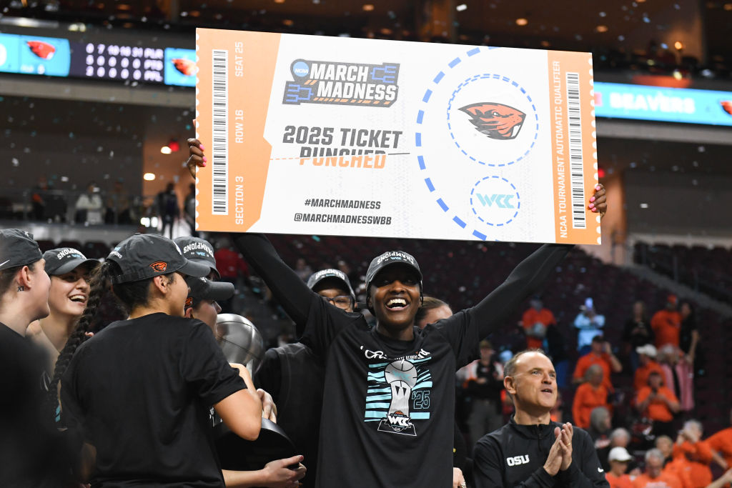 Catarina Ferreira #30 of the Oregon State Beavers holds up a ceremonial NCAA tournament ticket after the team's 59-46 victory over the Portland Pilots in the championship game of the West Coast Conference women's basketball tournament.