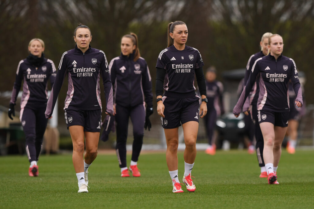 Caitlin Foord and Katie McCabe lead Arsenal onto the pitch to train for the Champions League quarterfinals.