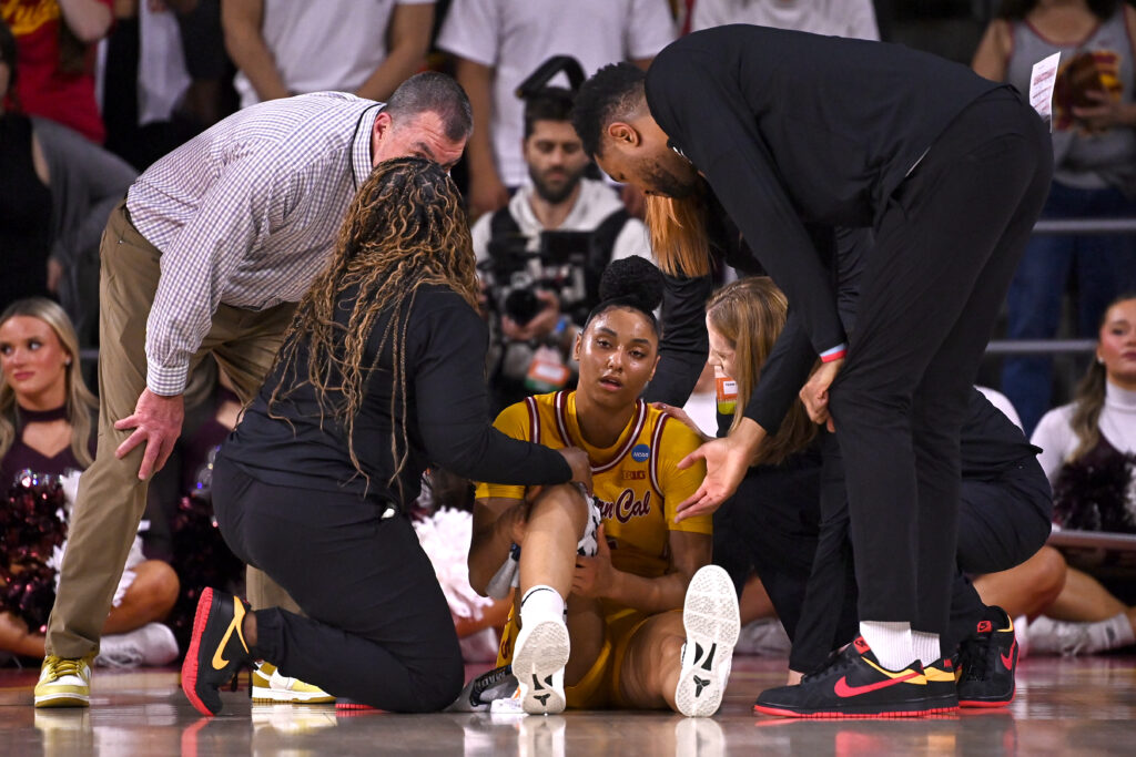 USC staff attend to JuJu Watkins after her season-ending injury in Monday's March Madness game.