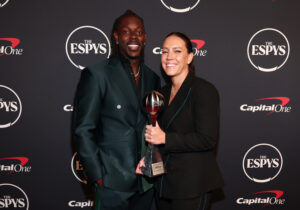 NBA star Jrue Holiday and USWNT World Cup champion Lauren Holiday pose at the 2023 ESPYS.