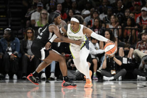 Las Vegas's Jackie Young defends Dallas's Arike Ogunbowale during a 2024 WNBA game.