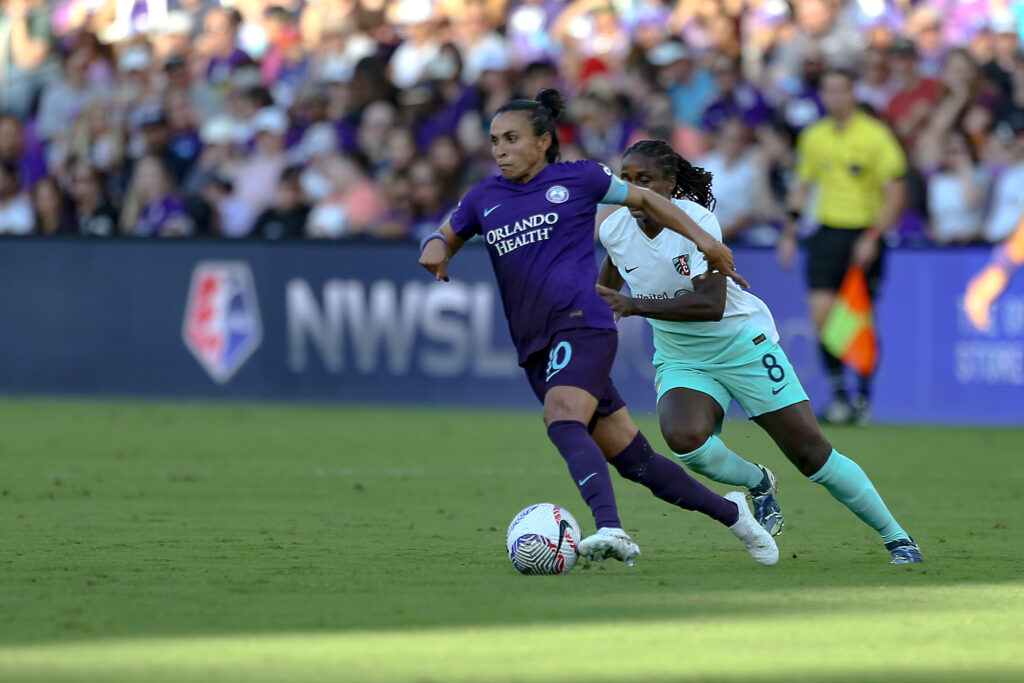 Orlando's Marta dribbles the ball past Kansas City's Nichelle Prince during the 2024 NWSL semifinals.