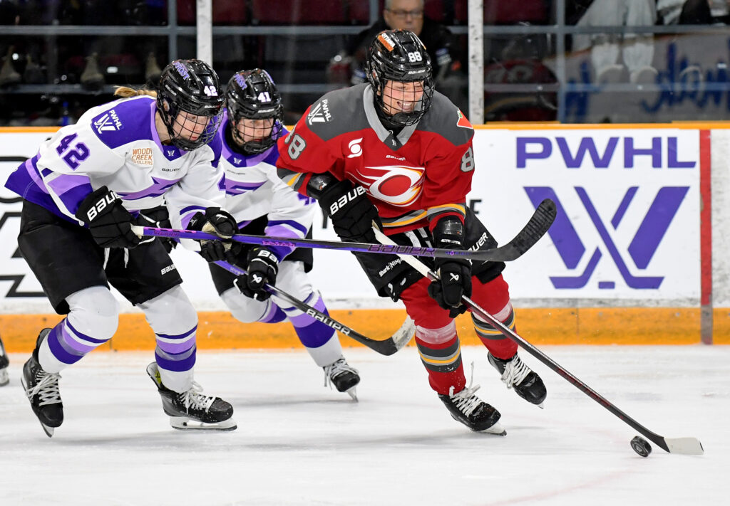 Minnesota's Denisa Krizova and Claire Thompson chase Ottawa's Ronja Savolainen, who controls the puck, during a 2025 PWHL game.