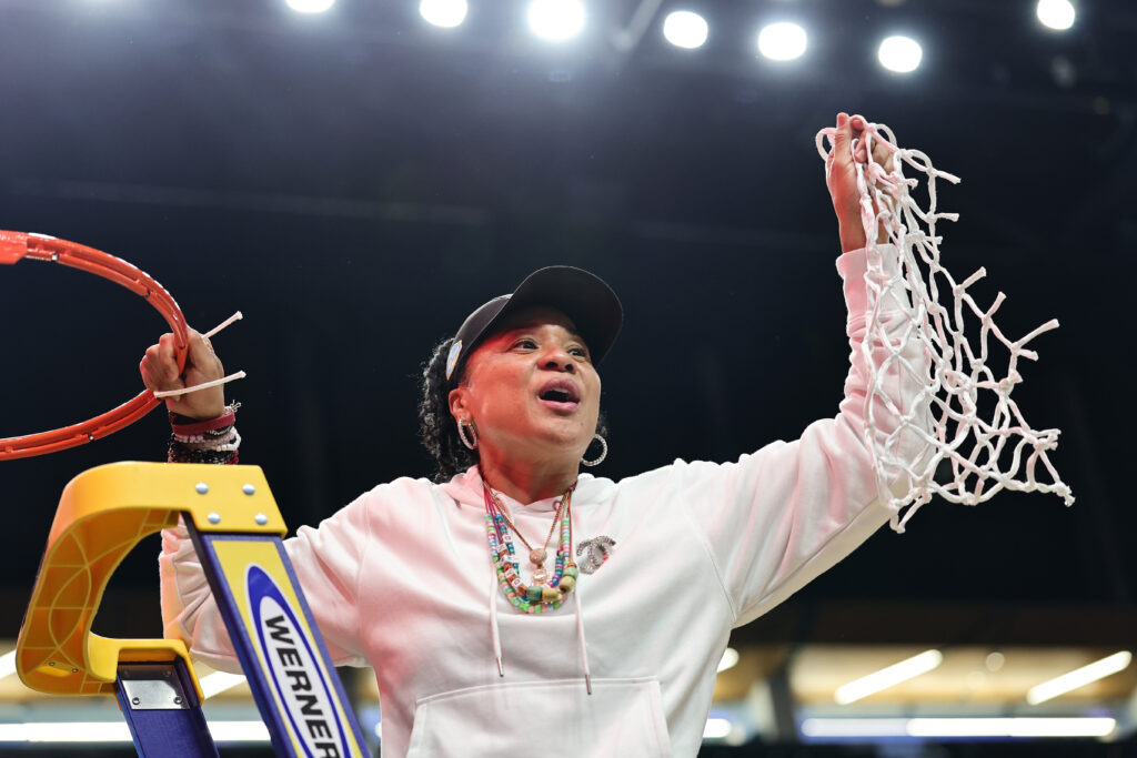 Head coach Dawn Staley cuts down the net after South Carolina's 2025 Elite Eight win.