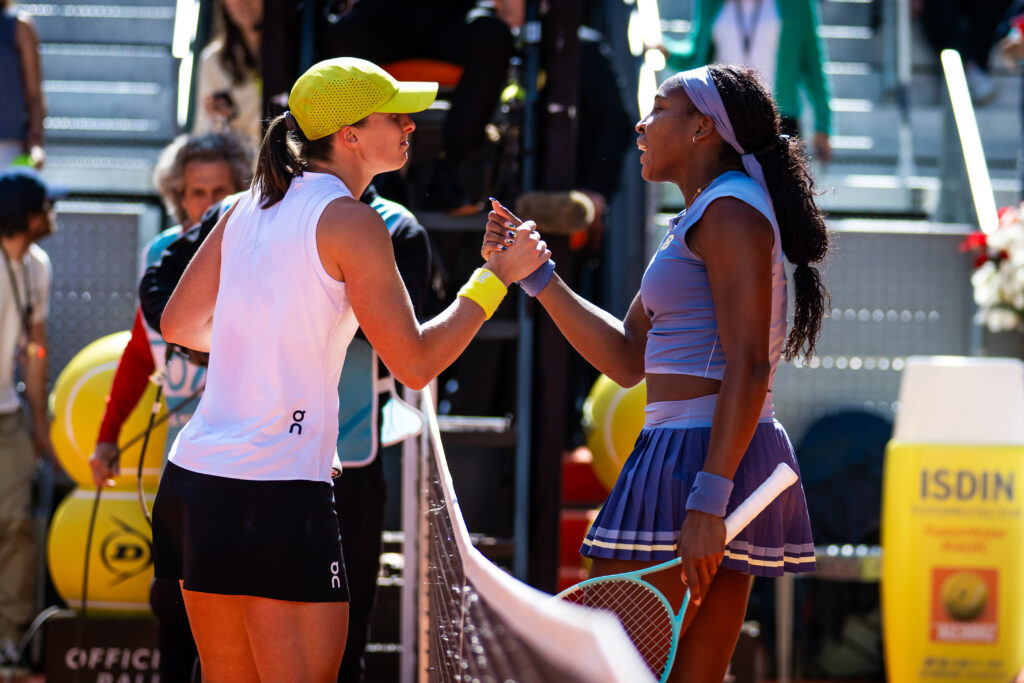 Iga Świątek and Coco Gauff shake hands at the net after their 2025 Madrid Open semifinal.