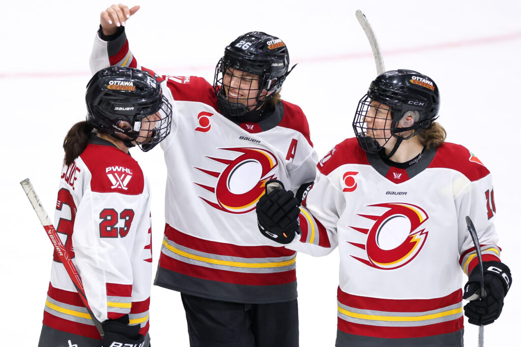 Ottawa's Jocelyne Larocque, Emily Clark, and Alexa Vasko celebrate a 2025 PWHL regular-season win.
