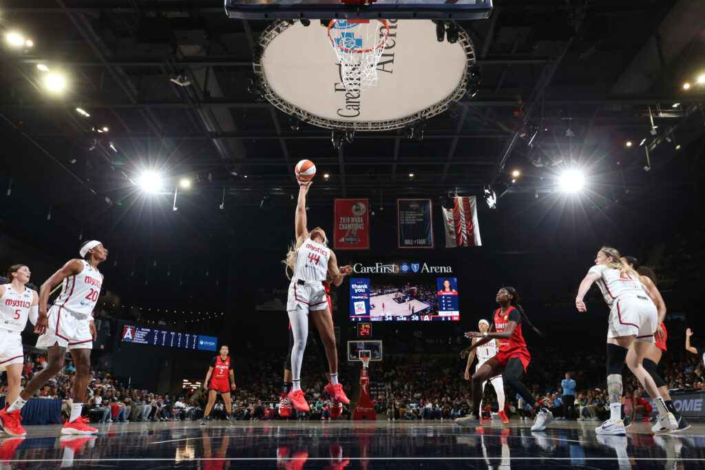 Washington rookie Kiki Iriafen leaps for a rebound during a 2025 WNBA season opening weekend game.