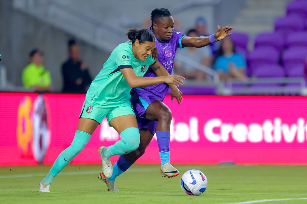 Kansas City center back Alana Cook battles Orlando striker Barbra Banda for the ball during a 2025 NWSL match.