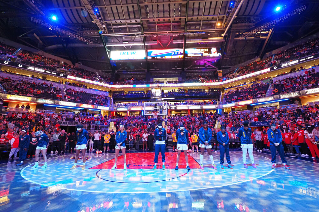 The Indiana Fever stands during the National Anthem at Gainbridge Fieldhouse before a 2025 WNBA game.
