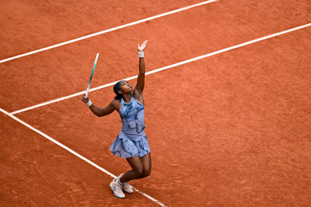US tennis star Coco Gauff tosses a serve in her first match at the 2025 French Open.