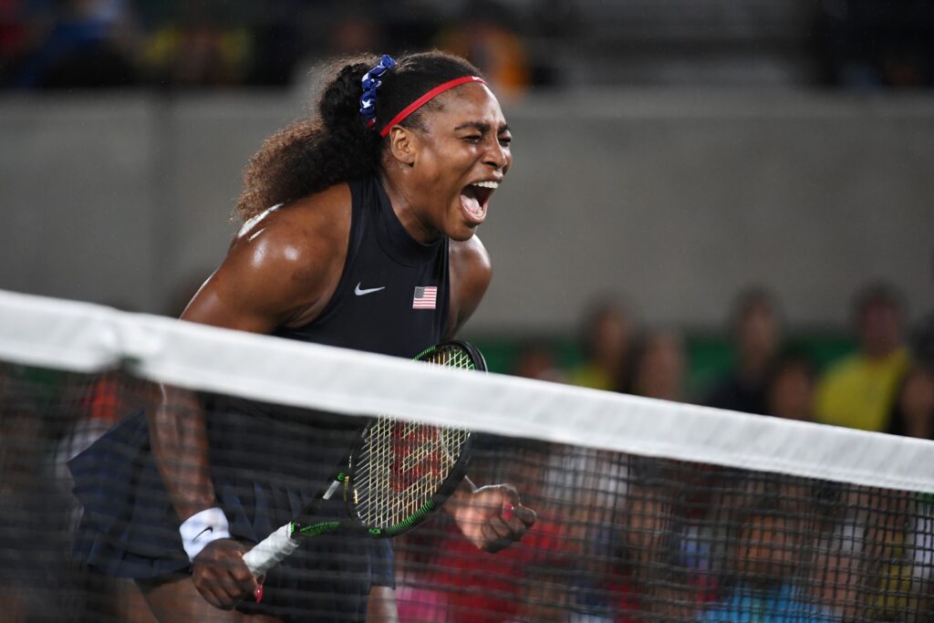 Serena Williams reacts after scoring a point during a 2016 Olympics tennis match.