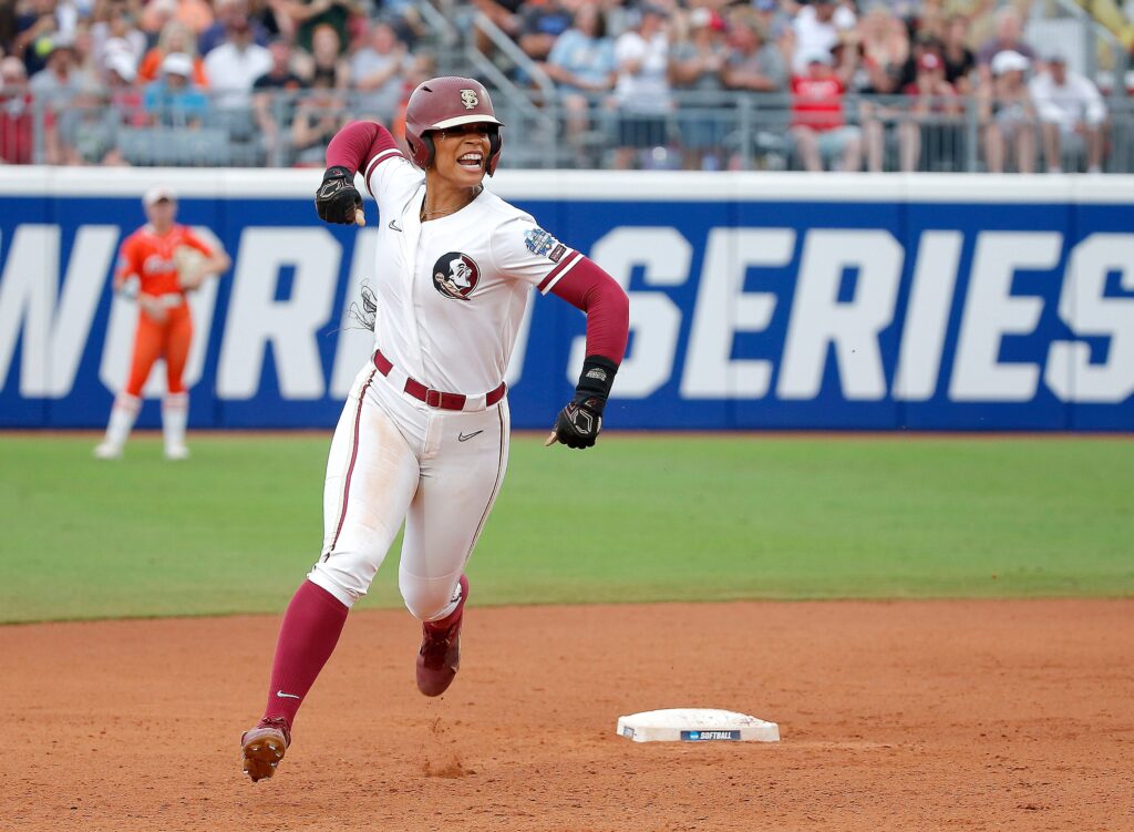 Florida State catcher Michaela Edenfield celebrates a home run while rounding second base during a 2023 Women's College World Series game.