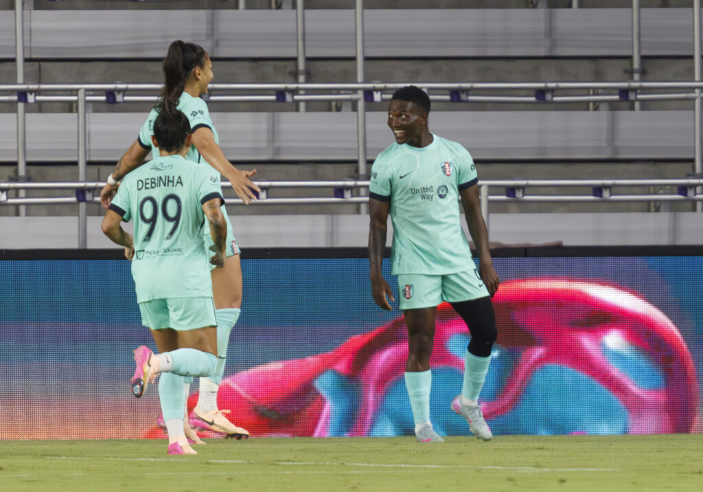 Temwa Chawinga celebrates her game-winning goal against Orlando with Kansas City teammates Bia Zaneratto and Debinha.
