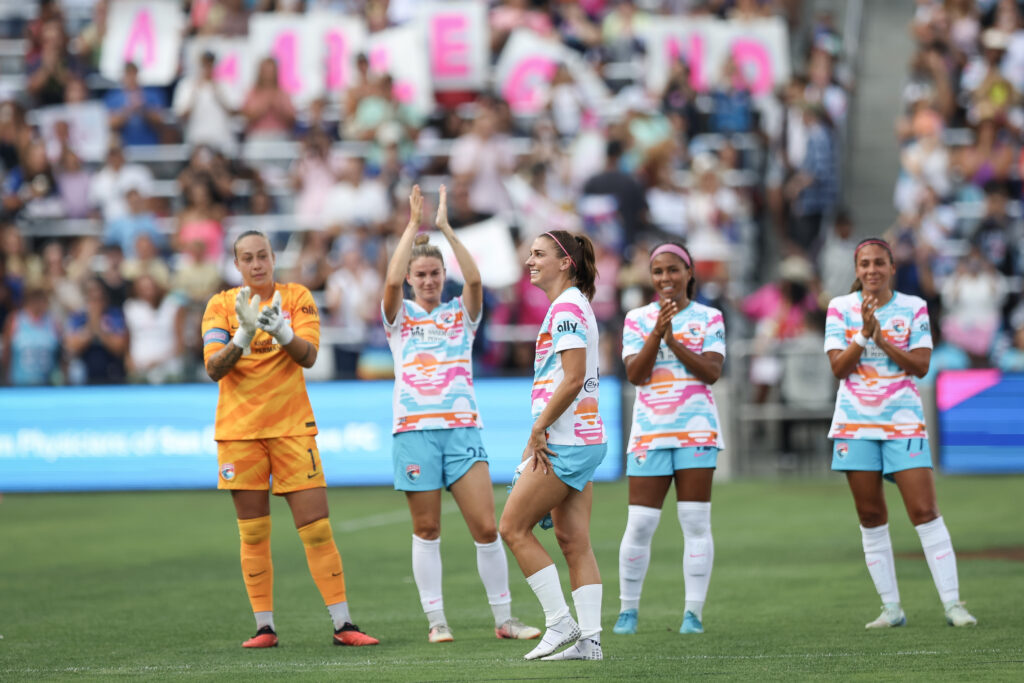 San Diego Wave players applaud Alex Morgan as she exits the pitch during her final NWSL game in 2024.